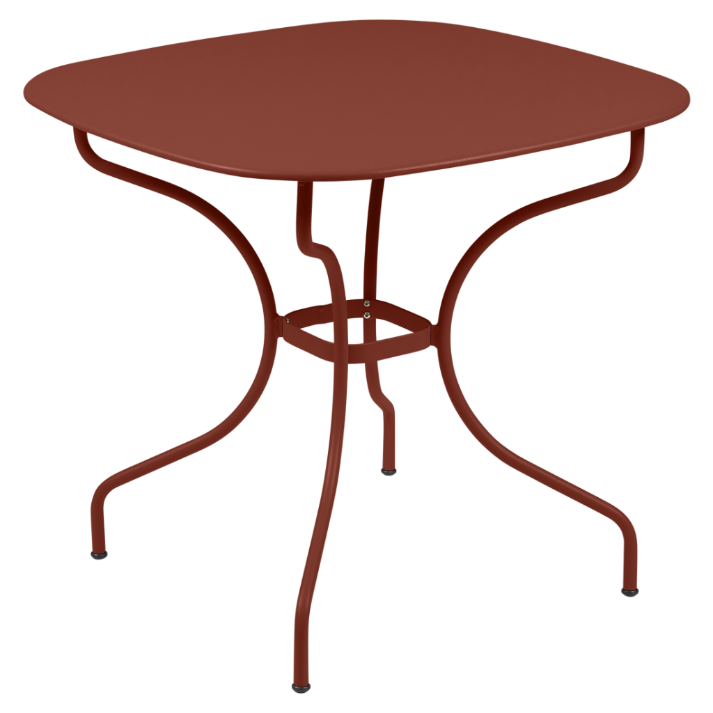 Une table en métal rouge avec un piètement en métal.