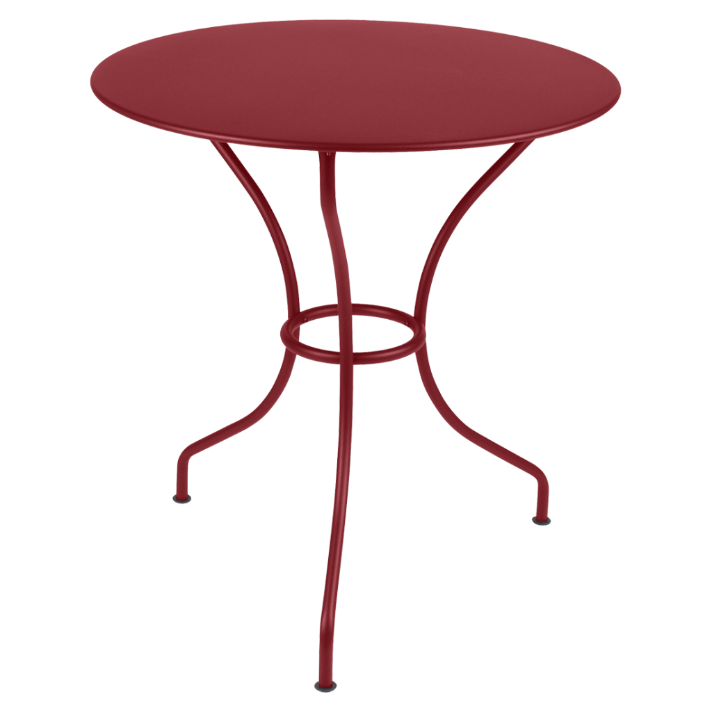 Une table ronde avec un piètement en métal rouge.