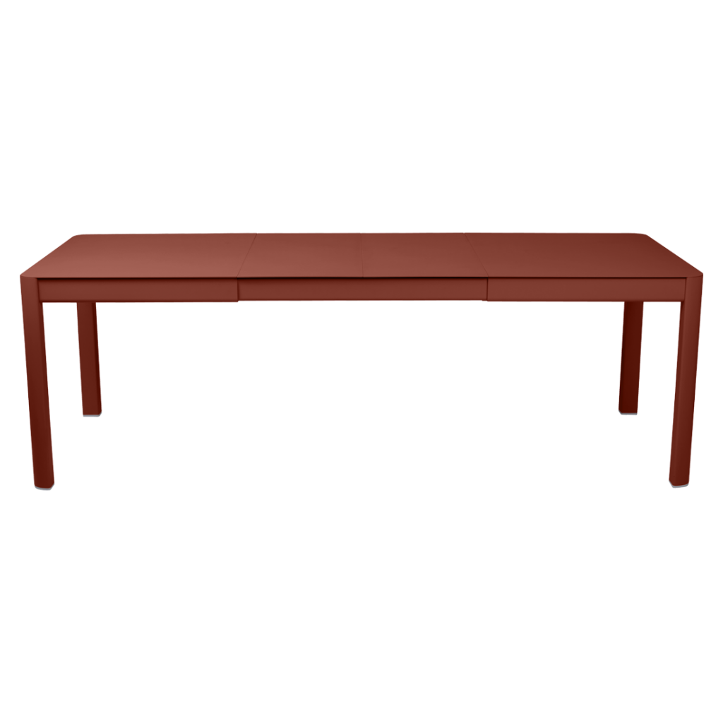 Une table à manger rouge sur fond blanc.