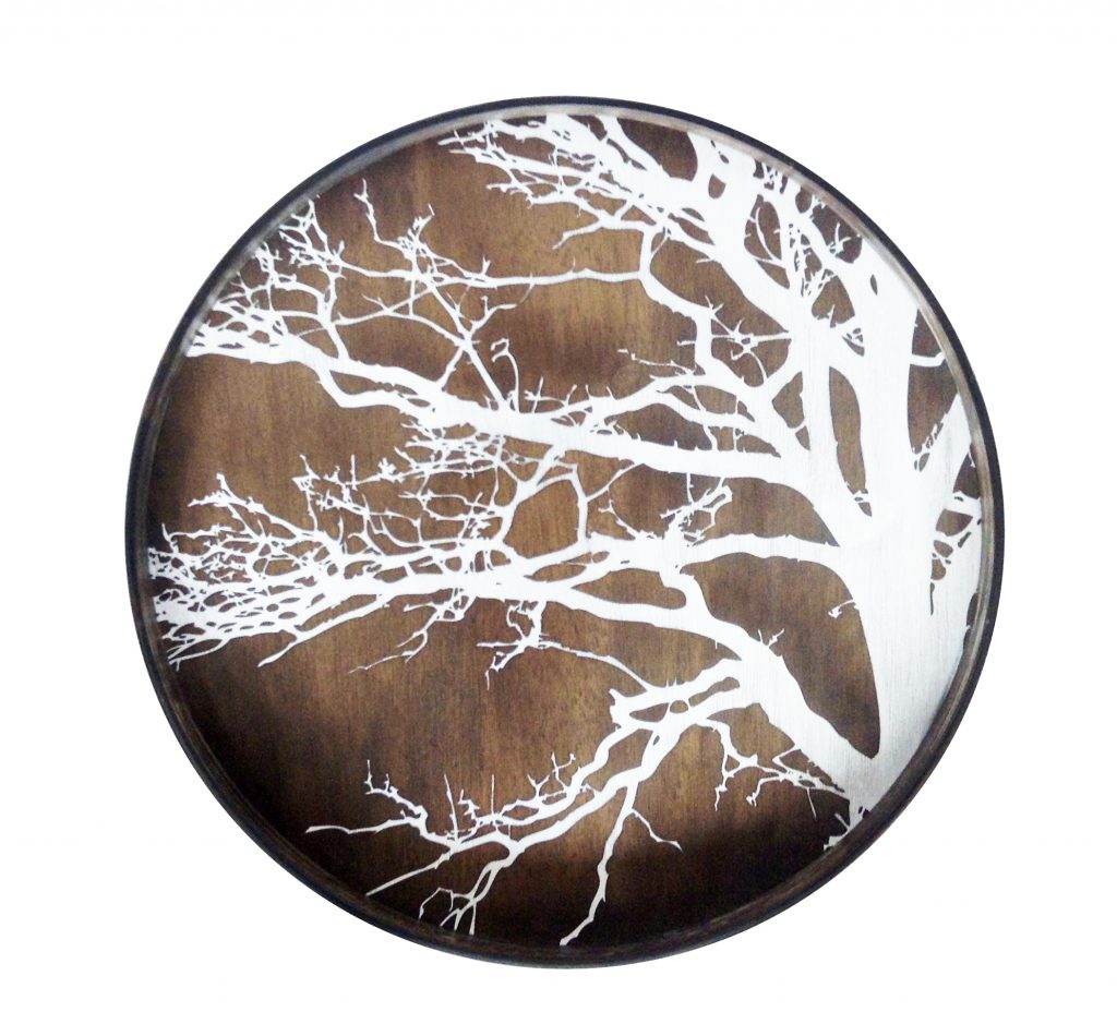 Un plateau rond en bois avec un arbre blanc dessus.