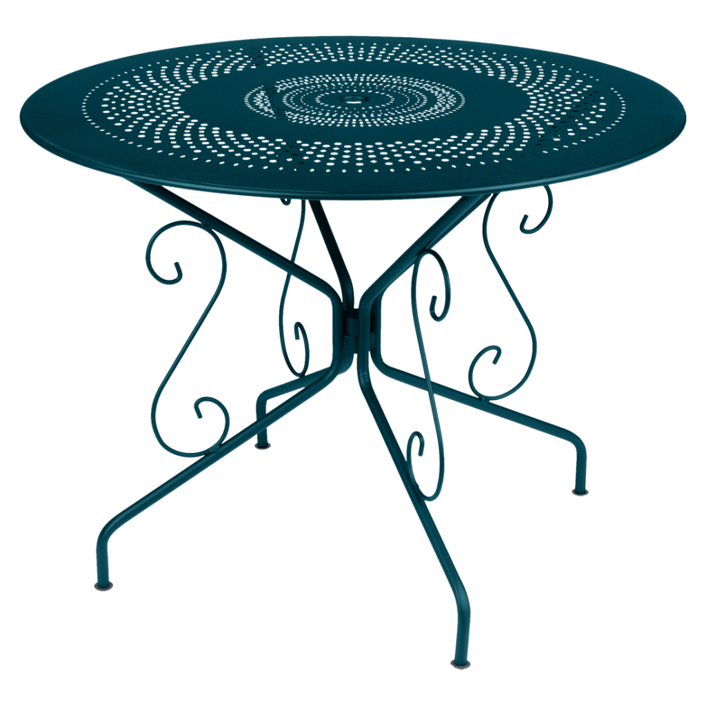 Une table en métal bleu sarcelle au design orné.