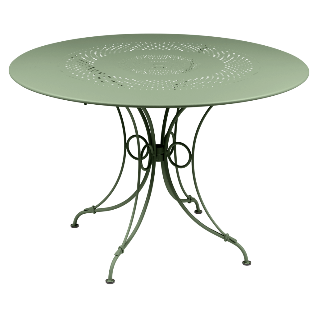 Une table ronde avec un piètement en métal vert.