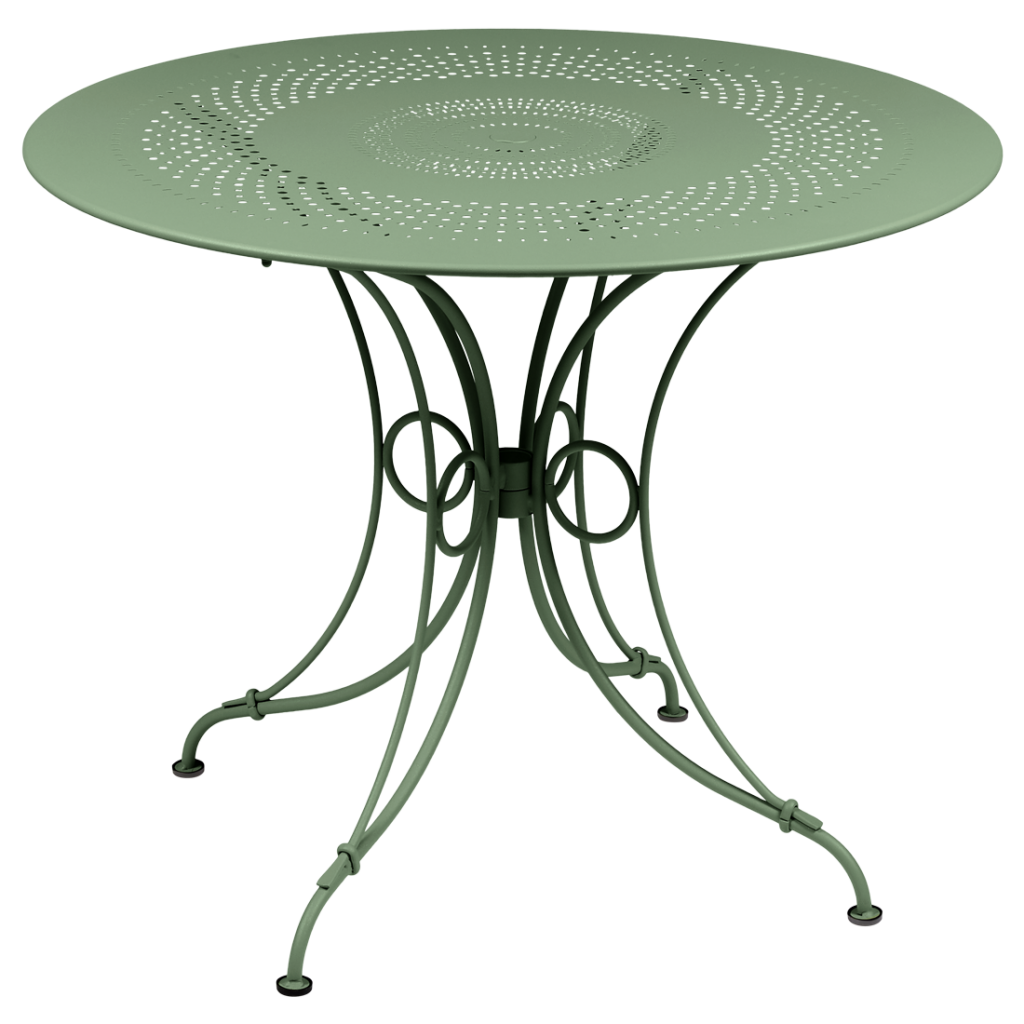 Une table ronde avec un piètement en métal vert.
