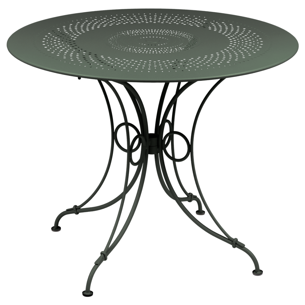 Une table ronde avec un piètement en métal vert.