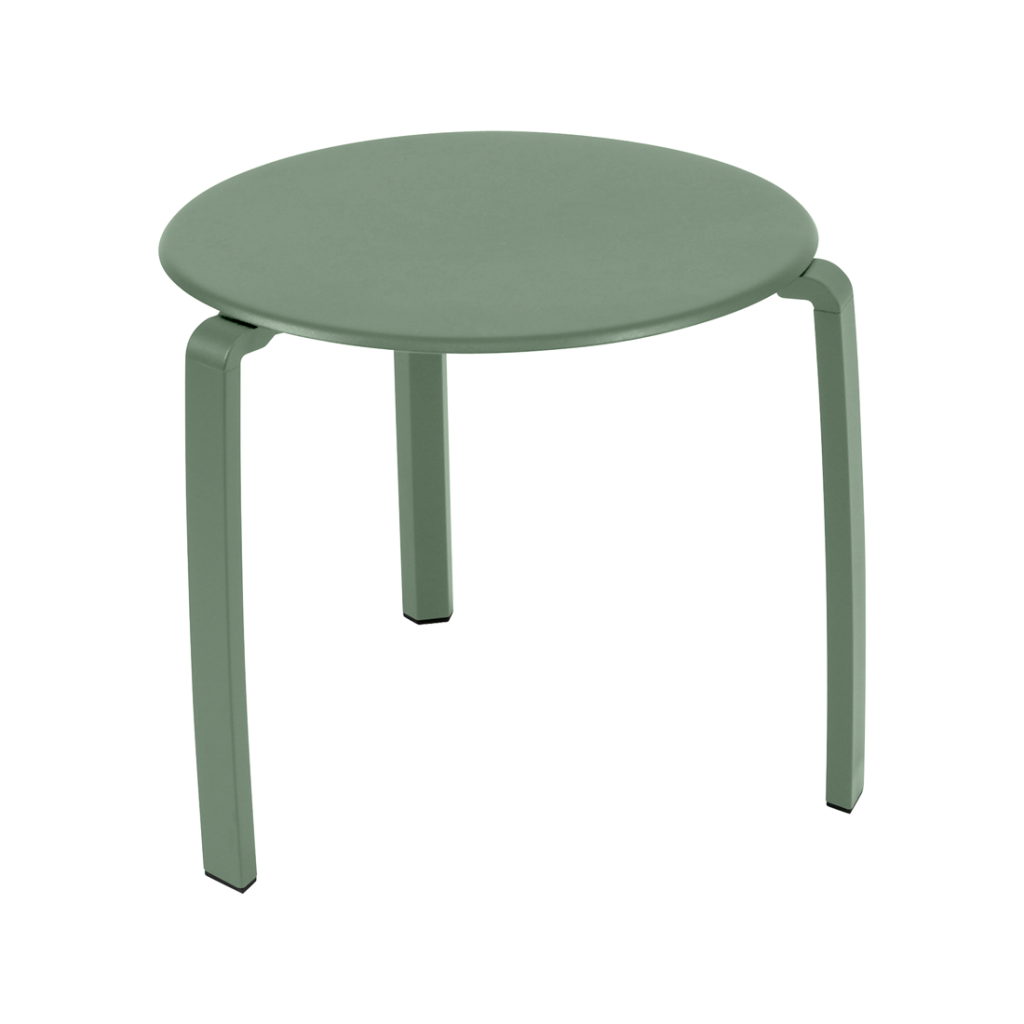 Une table d'appoint verte avec des pieds en métal.