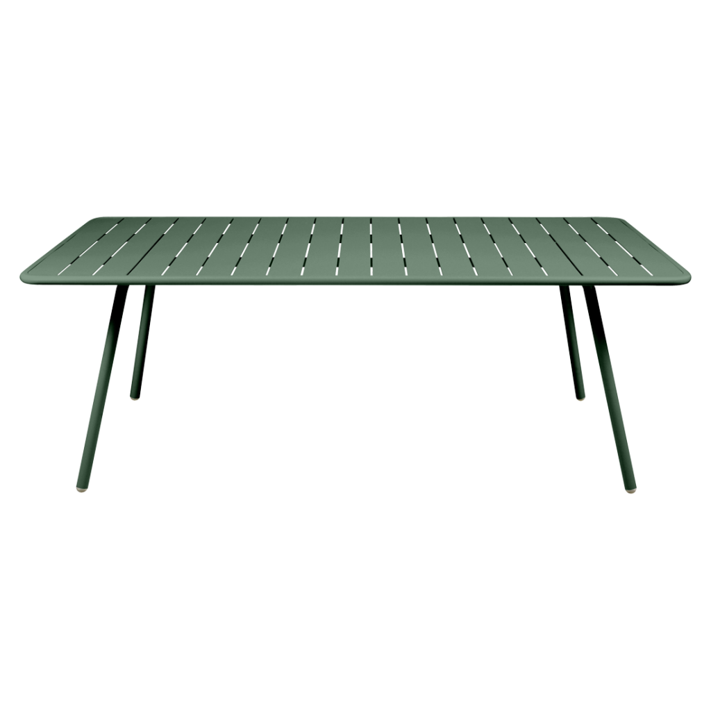 Une table verte avec des pieds.