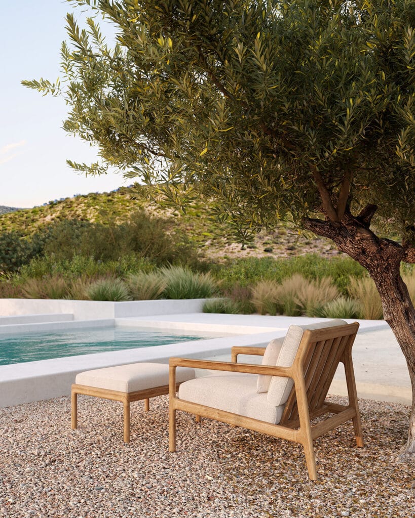 Un fauteuil de jardin Jack en teck à côté d'une piscine.