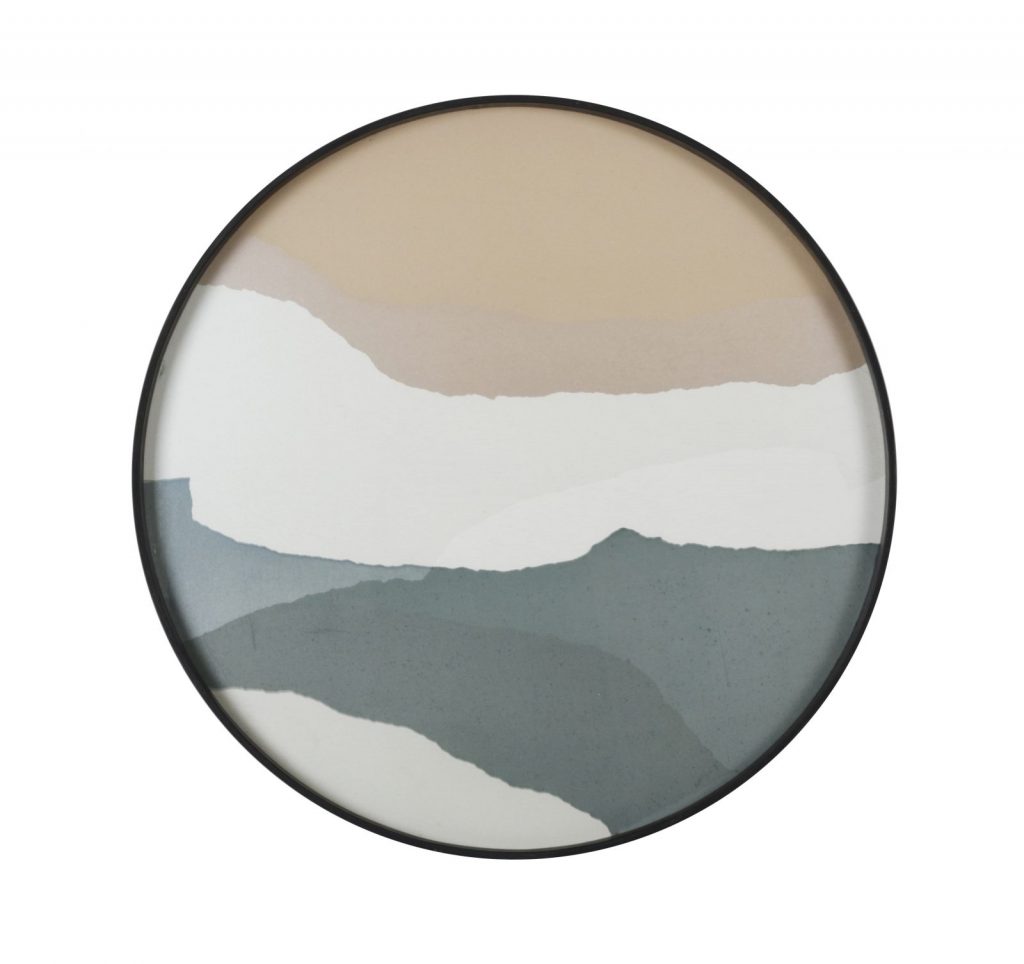 Un tableau abstrait dans un cadre rond, disponible au magasin de meubles design.