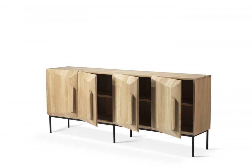 Un buffet en bois avec pieds et portes noirs.