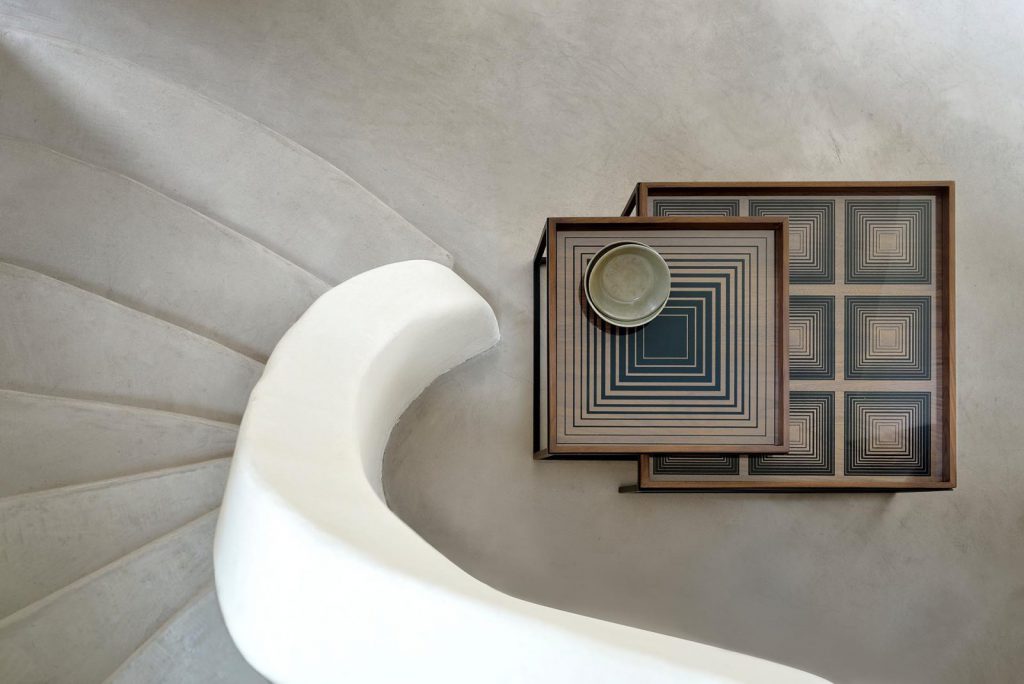 Un plateau blanc se trouve au sommet d’un escalier en colimaçon.