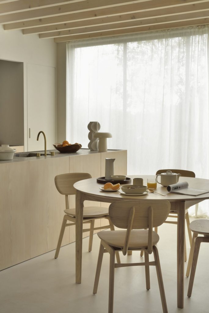 Une cuisine avec une table et des chaises en bois.