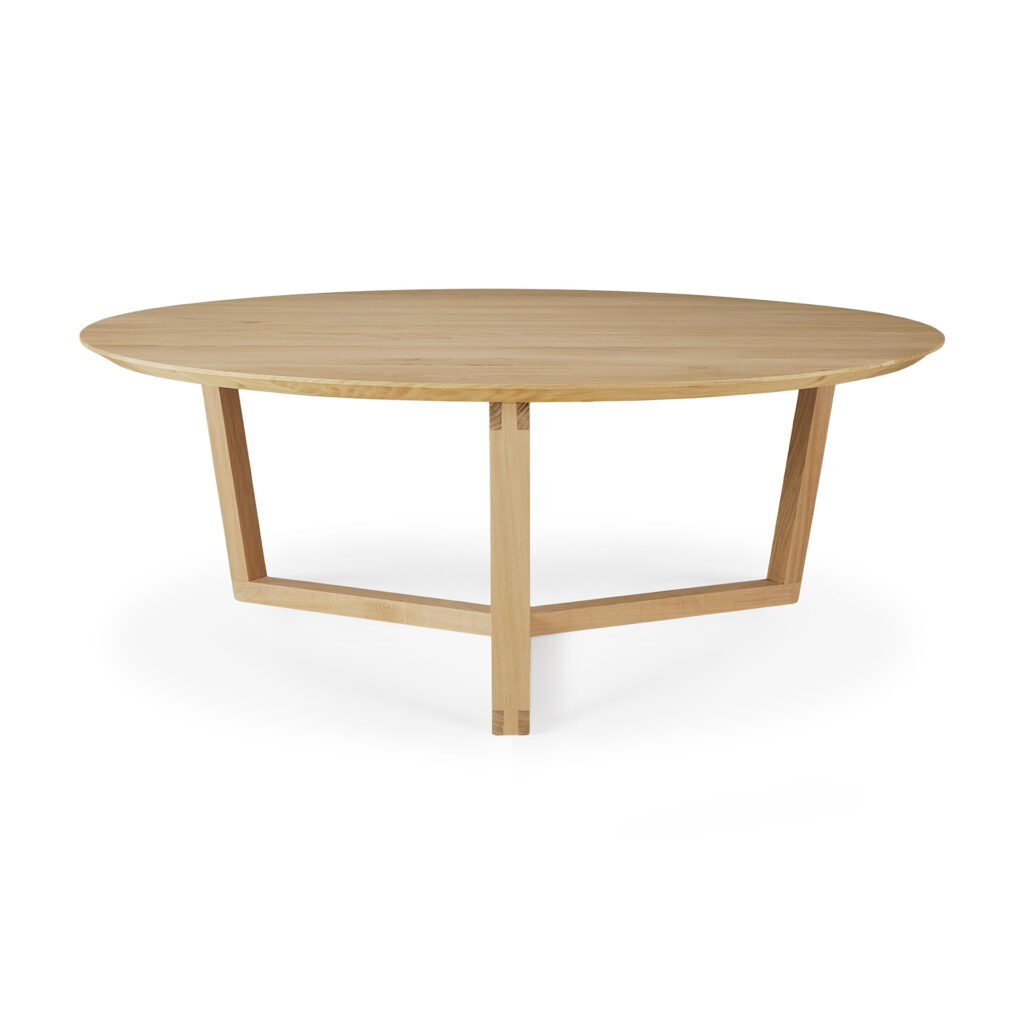 La table basse Tripod en chêne présente un plateau rond en bois avec un design élégant et moderne et trois pieds inclinés qui ressemblent à un trépied élégant.