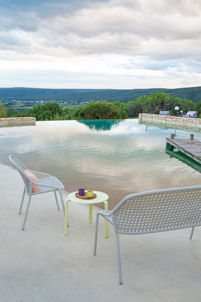 Une table basse Alize au bord d'une piscine.