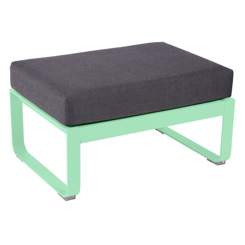 Un pouf vert avec un coussin gris.