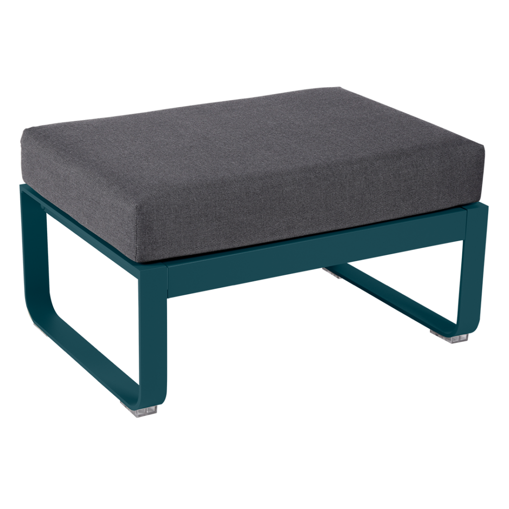 Un pouf bleu sarcelle avec un coussin gris.