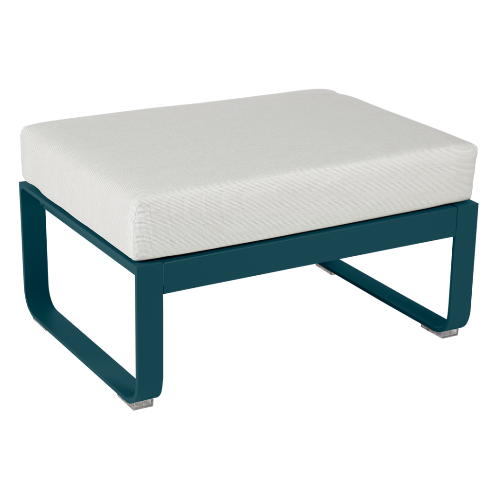 Un pouf bleu sarcelle avec un coussin blanc.