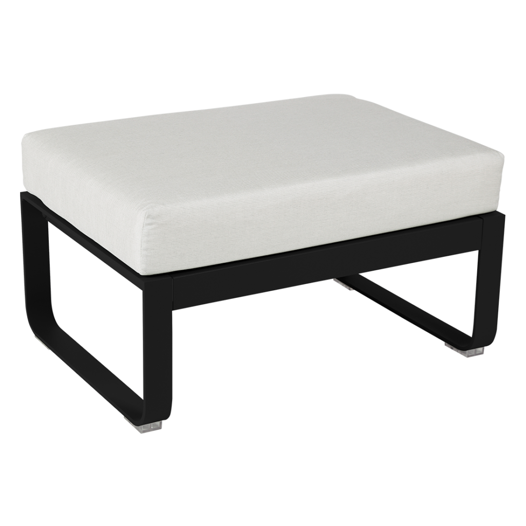 Un pouf noir et blanc avec un coussin blanc.