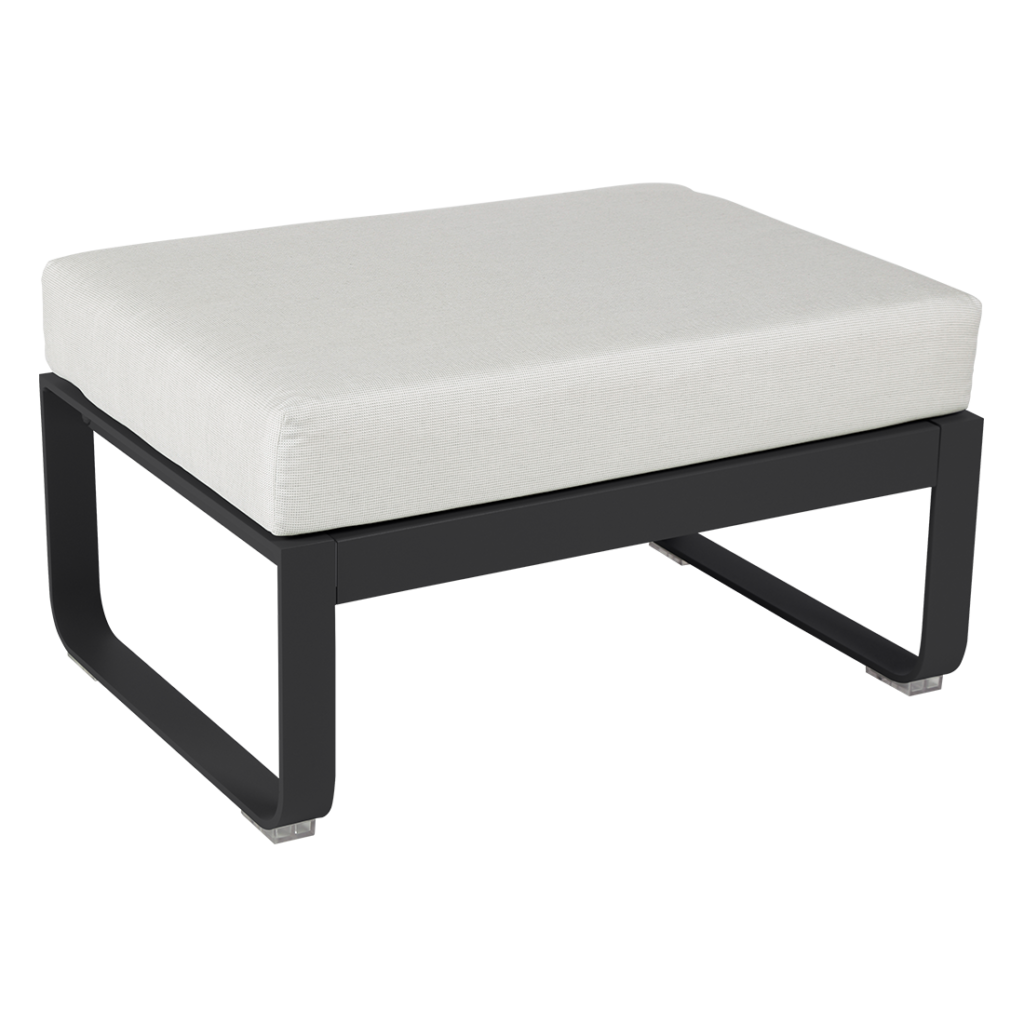 Un pouf noir et blanc avec un coussin blanc.