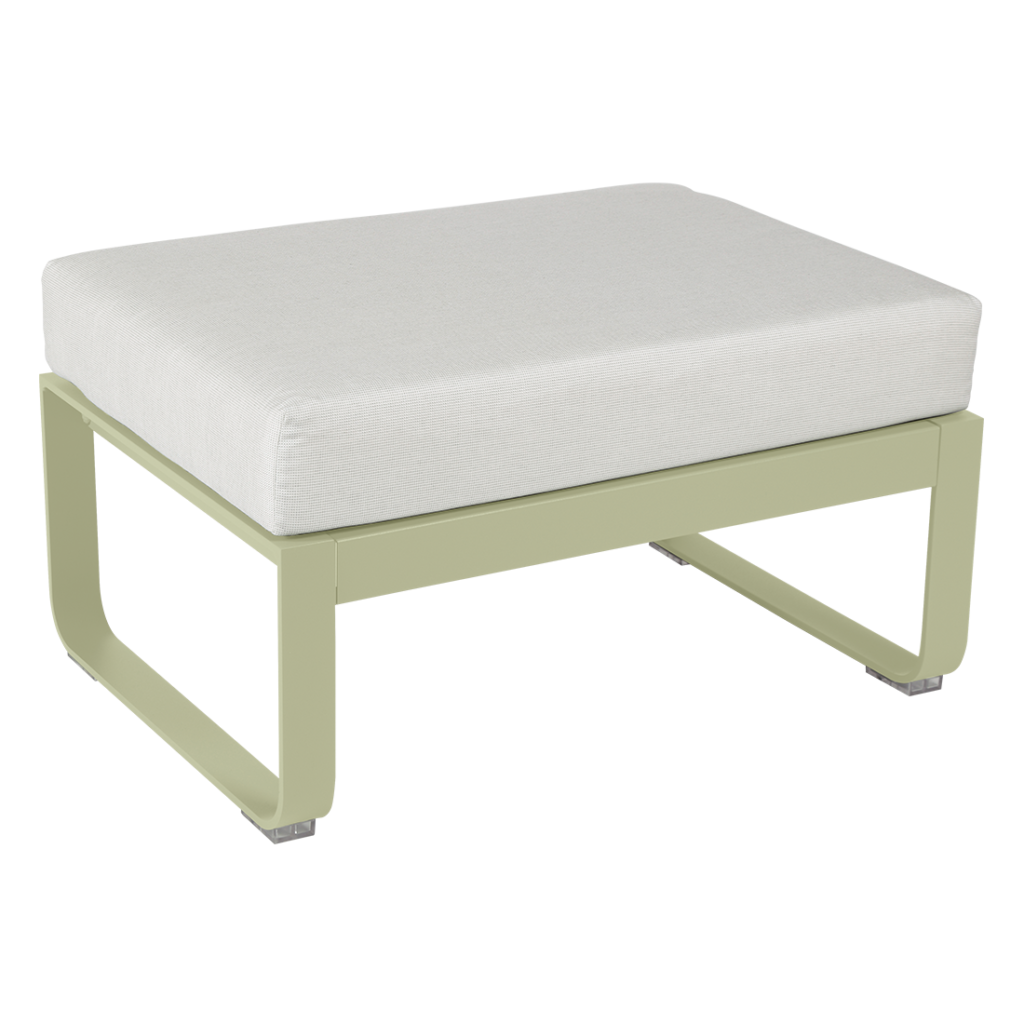 Un pouf vert avec un coussin blanc.