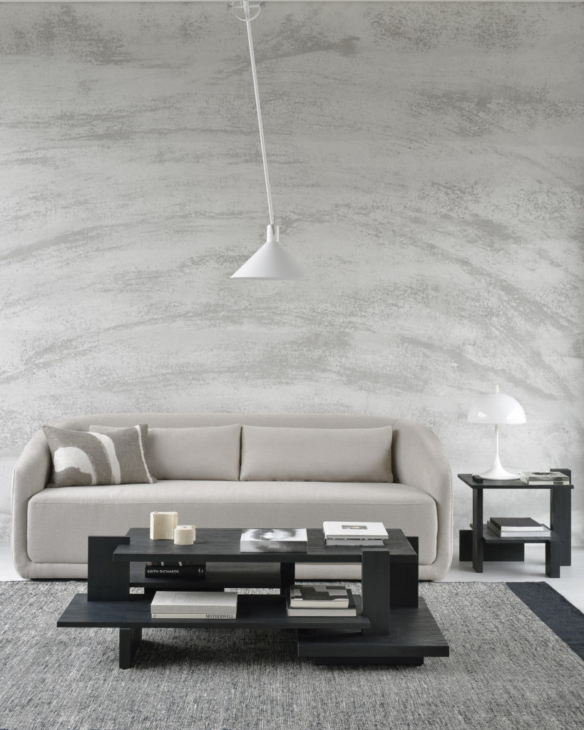 Un salon moderne avec un canapé et une table d'appoint Abstract en teck.