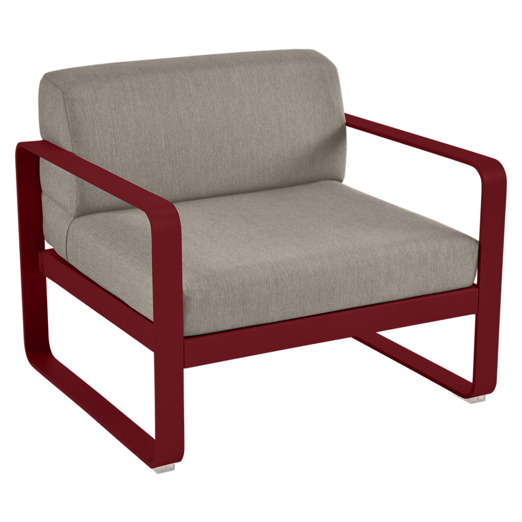 Une chaise longue rouge avec un coussin beige.