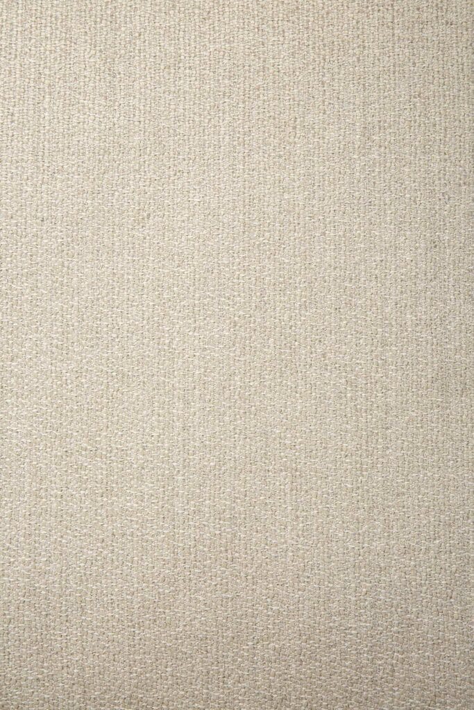 Un gros plan d'un Canapé Mellow, module 1 place, fond en tissu beige.