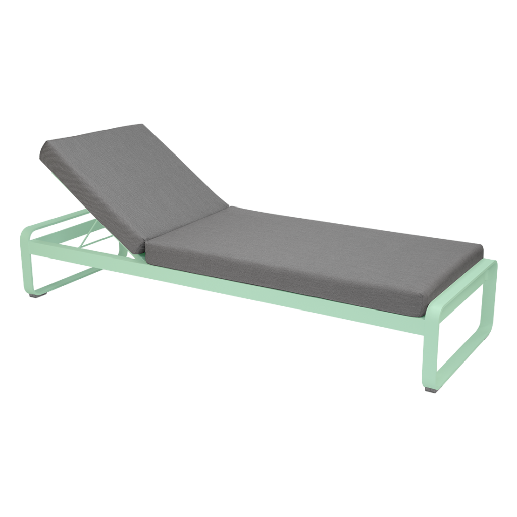 Une chaise longue avec un coussin vert sur fond blanc.