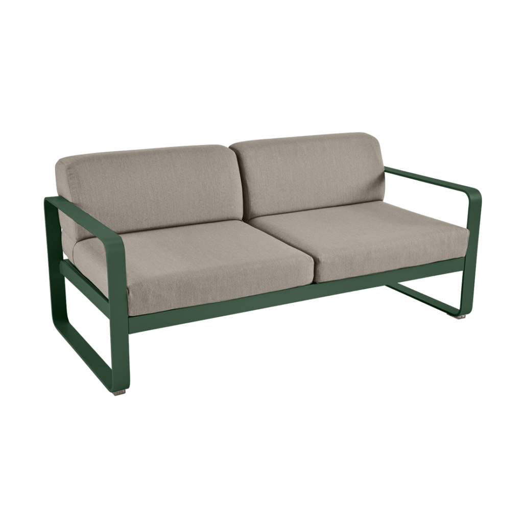 Un canapé vert avec un coussin beige.