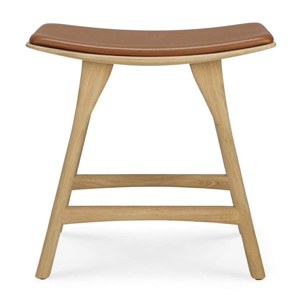 Un tabouret Osso en Chêne naturel vernis avec une assise en cuir marron.