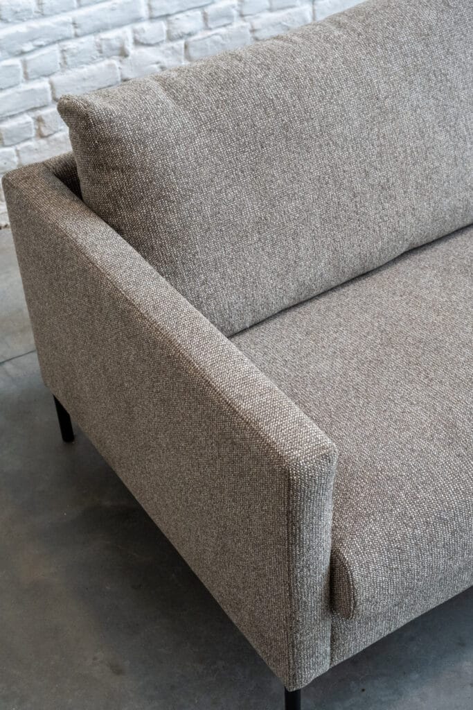 Un Canapé Impulse, tissu Sneak aux pattes noires.