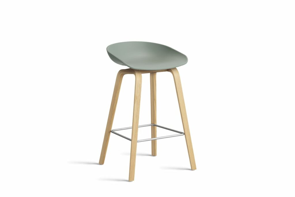 Un tabouret Tabouret vert avec des pieds en bois.