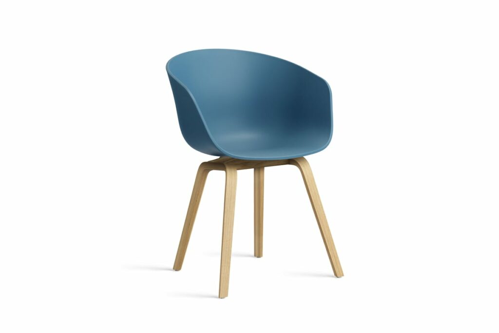 Une chaise bleue avec des pieds en bois sur fond blanc.
