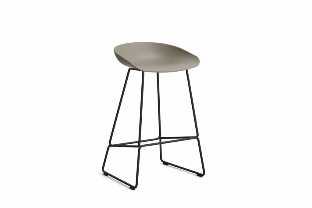 Le Tabouret AAS38 présente des pieds noirs et un siège beige, créant un tabouret de bar élégant.