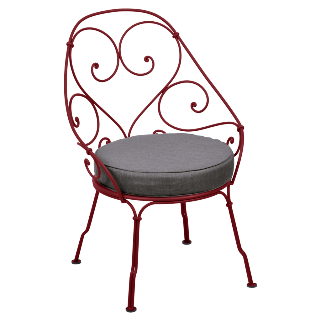 Une chaise Fauteuil Cabriolet rouge avec un coussin datant de 1900.