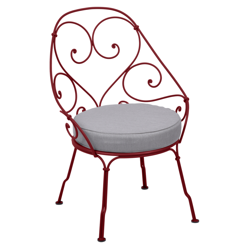 Une chaise Fauteuil Cabriolet rouge des années 1900 avec un coussin gris.