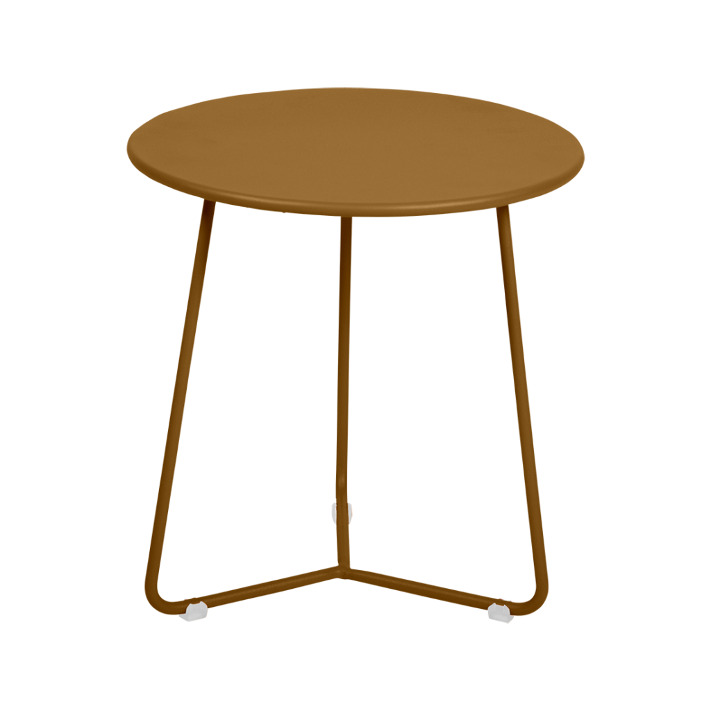 Une table d'appoint avec des pieds en métal et un plateau rond.
