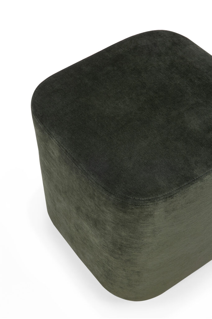 Un pouf carré vert foncé aux bords arrondis, recouvert d'un tissu doux cannelle.