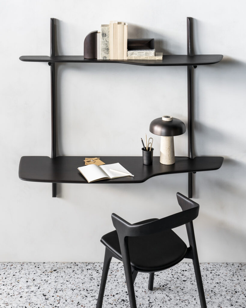 Le bureau mural PI, disponible dans un design noir minimaliste, est livré avec une chaise assortie, une lampe élégante, des livres très appréciés et des articles de papeterie essentiels.