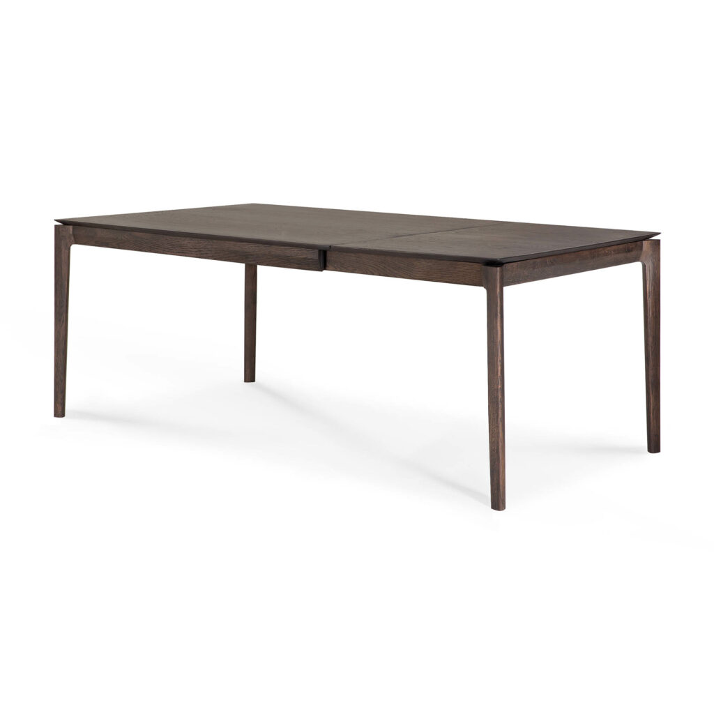 Table à manger rectangulaire extensible en bois foncé Bok 140- avec quatre pieds fins, s'étendant légèrement vers l'extérieur. La table à manger est simple, moderne et se dresse sur un fond blanc uni.