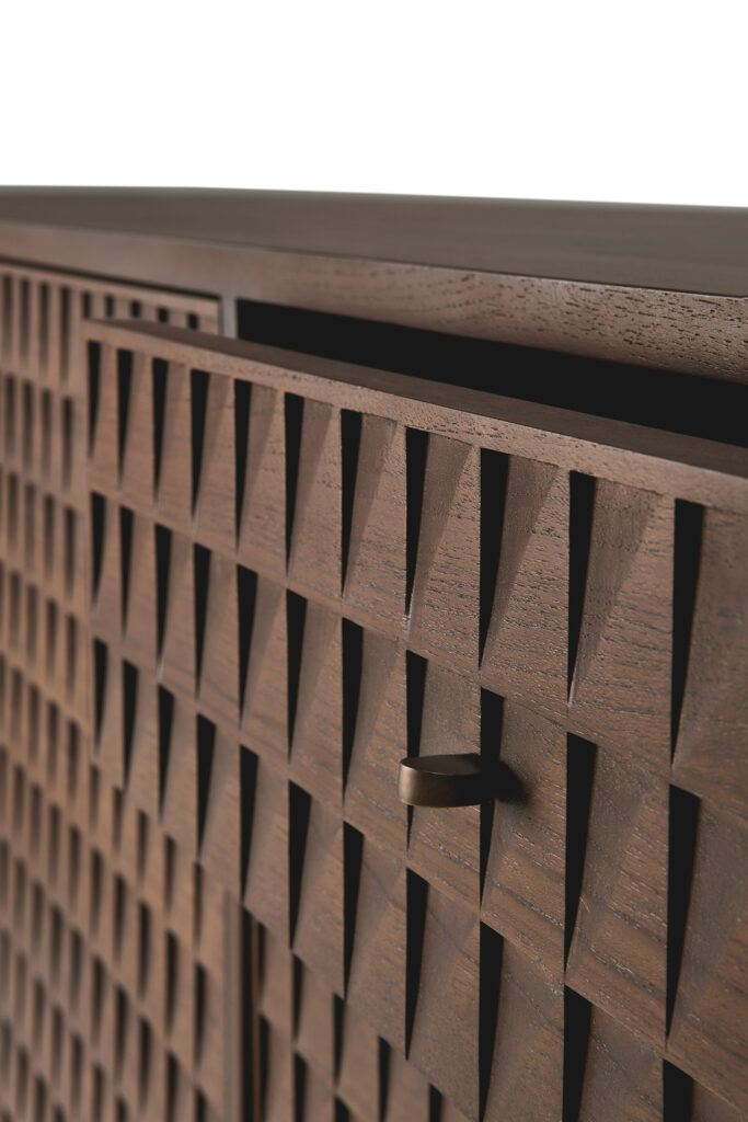 Gros plan de la porte de l'armoire en bois de Buffet Sono, présentant un motif triangulaire géométrique et une poignée en laiton, partiellement ouverte.
