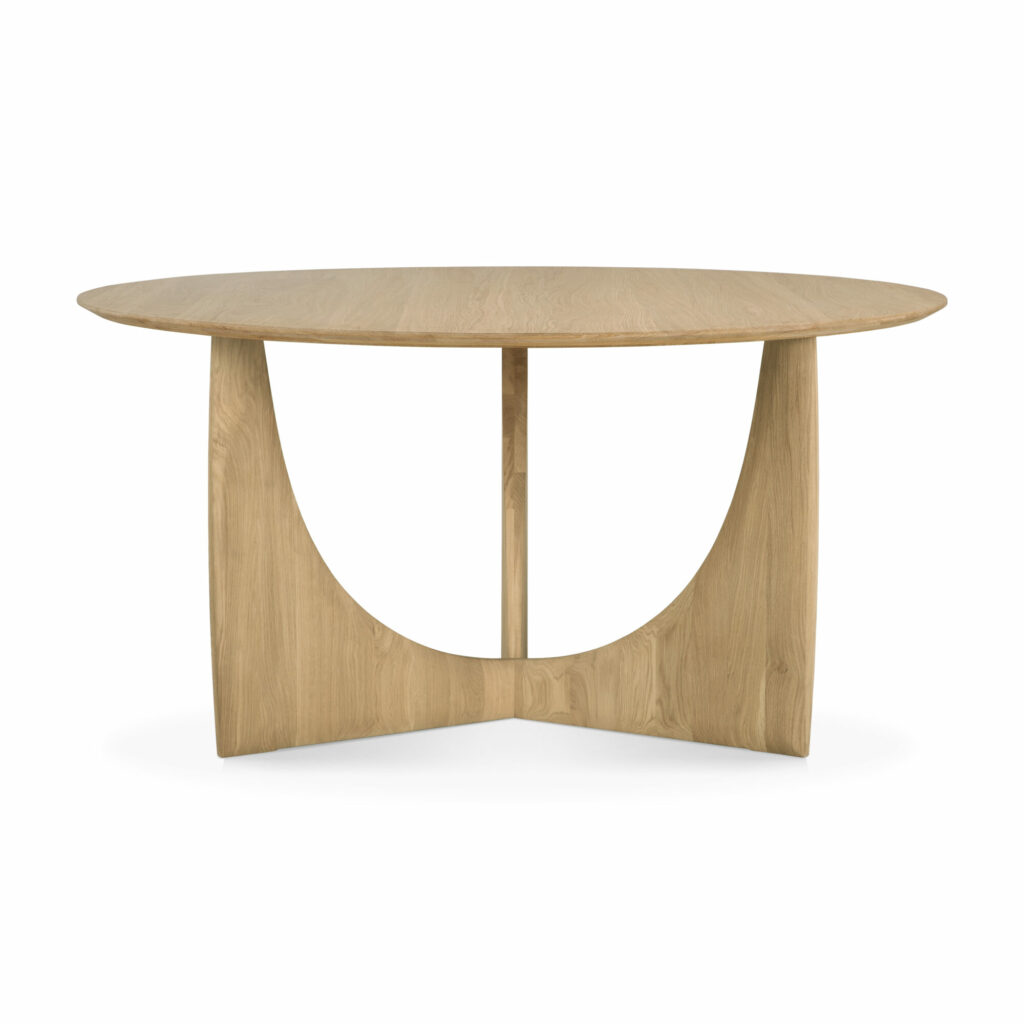 Une table ronde en bois de chêne huilé avec une surface lisse et une base géométrique moderne.