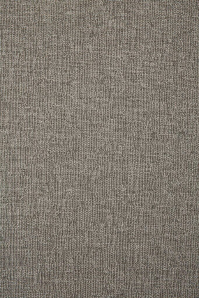 Gros plan d'une surface en tissu gris texturé présentant un motif tissé, rappelant l'élégance caractéristique de la chaise longue d'extérieur Corbey.