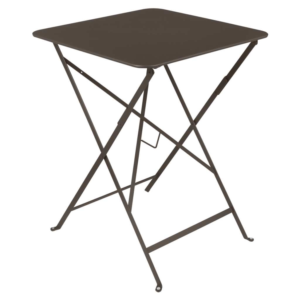 Une petite table pliante carrée noire aux pieds en métal se détache gracieusement sur un fond violet clair, rappelant une ambiance de bistrot classique de table carrée.
