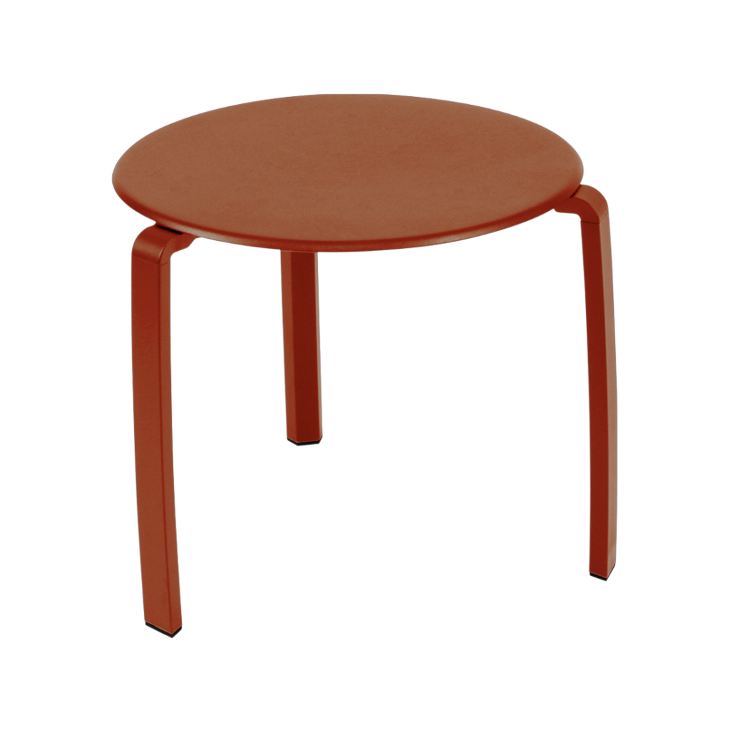 Un tabouret rond à trois pieds, à la finition rouge rouille et au design minimaliste, parfait comme table basse ou pièce d'appoint. Présenté sur fond blanc.