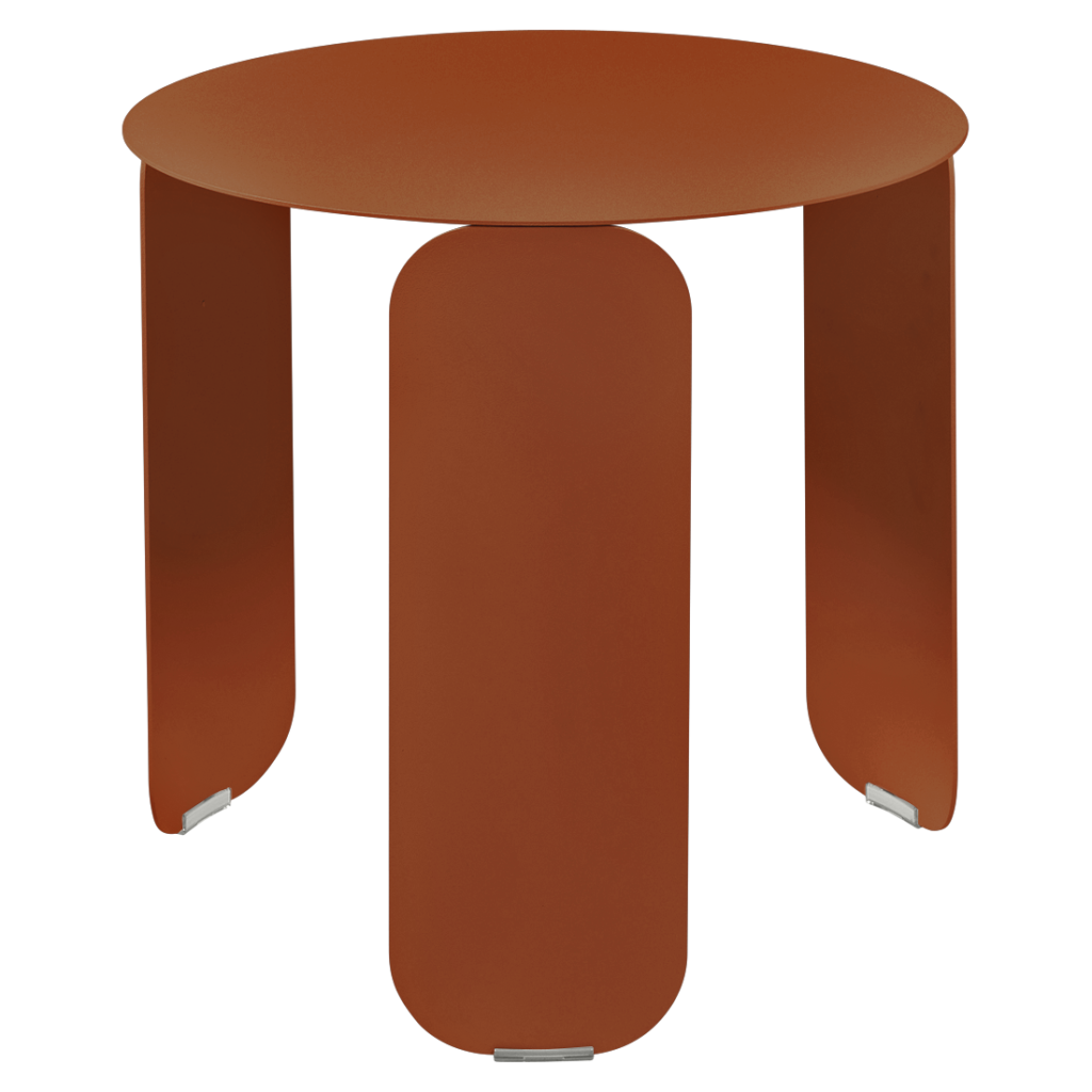 Une table basse Bebop ronde de couleur rouille dotée de trois pieds plats et courbés avec des embouts métalliques à la base de chaque pied.