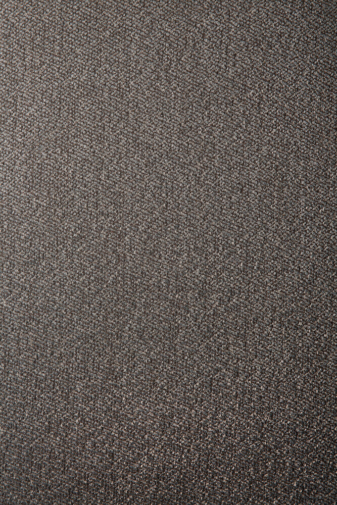 Vue rapprochée d'une surface brune texturée, peut-être en tissu ou en tissu d'ameublement, avec un motif fin et tissé et un éclat subtil.