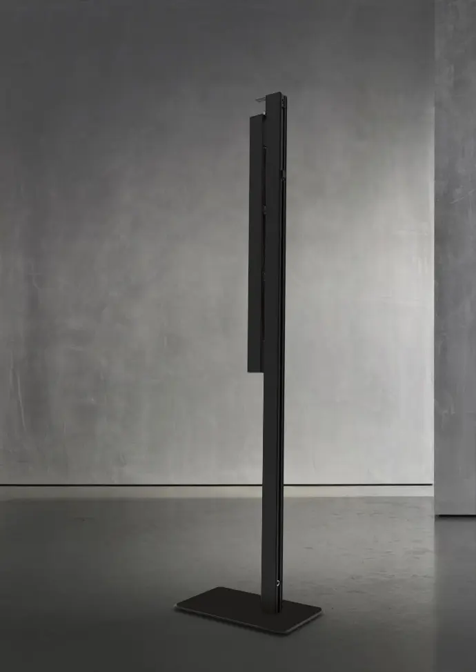 Le TWIG FS - Midnight (230V, EU) est un appareil noir vertical et élégant sur une base rectangulaire, placé contre un mur gris uni. Il offre des performances fiables et un style moderne pour les besoins en électricité de l'UE en 230V.