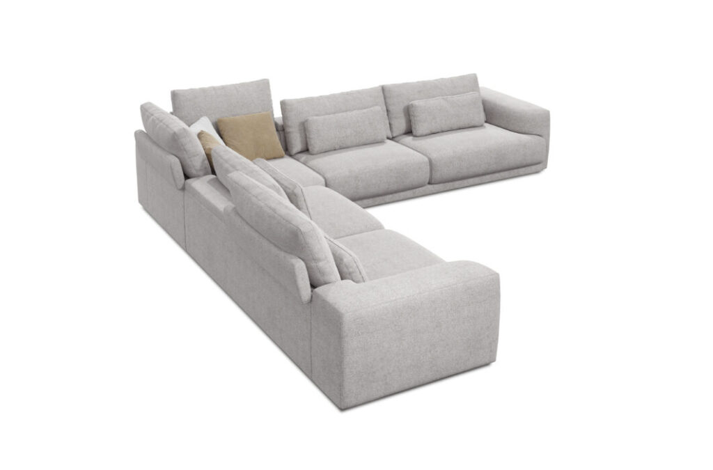 Le Canapé Willow [4z-Nzz-4z] - C25 Perfect Harmony est un canapé sectionnel gris clair en forme de L avec plusieurs coussins de dossier et un coussin d'appoint beige, présenté sur un fond blanc.