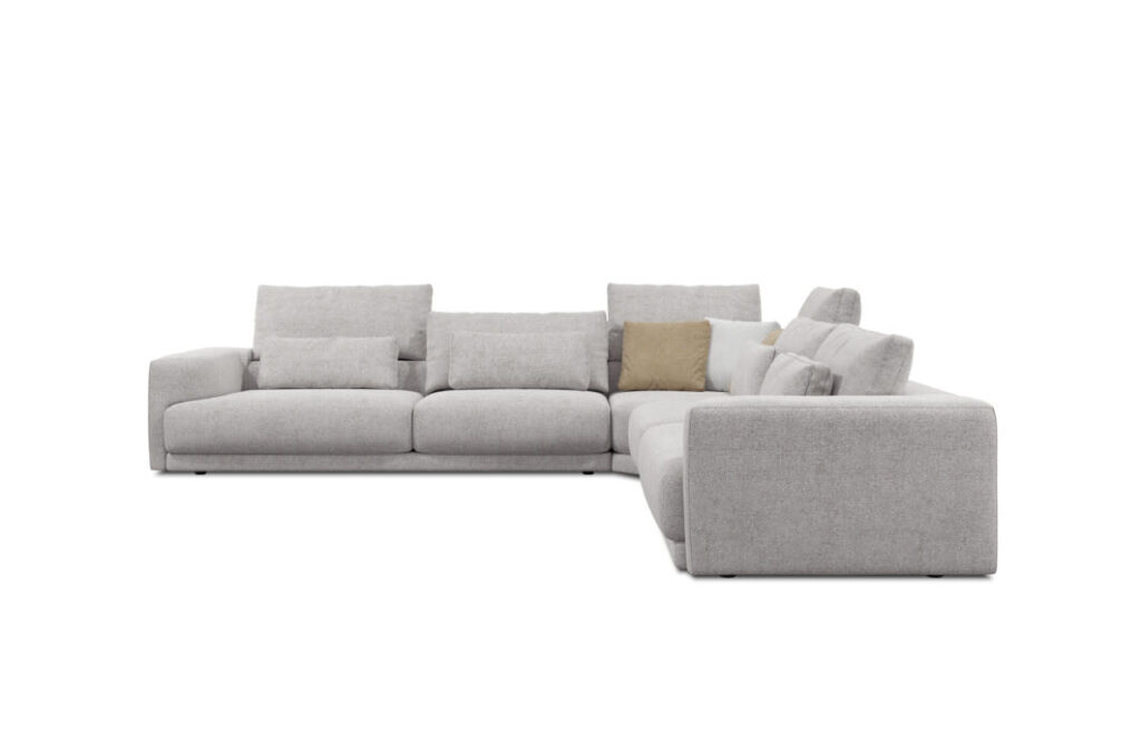 Le Canapé Willow [4z-Nzz-4z] - C25 Perfect Harmony est un sectionnel moderne en forme de L gris clair avec plusieurs coussins, dont un beige, présentés sur un fond blanc uni.