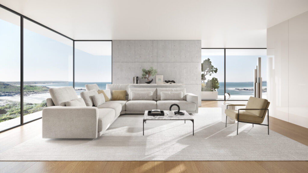 Un salon moderne doté du canapé Willow [4z-Nzz-4z], d'un décor minimaliste, de fenêtres allant du sol au plafond avec vue sur l'océan et de planchers en bois clair crée l'atmosphère C25 Perfect Harmony.